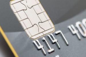 Close-up of a credit card highlighting the EMV chip technology on the card