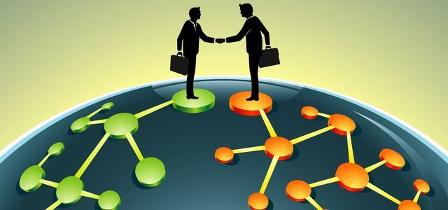 Concept of Vantiv-Worldpay global business merger with two businessmen shaking hands on top of the globe.